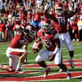 Running back Dennis Johnson (33) scores Arkansas’ first touchdown, an 8-yard run in the first quarte...