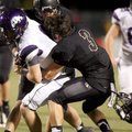 Austin Allen, Fayetteville’s senior quarterback, is tackled by Bentonville senior defensive back Chr...