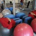 Betty Mullenix does sit-ups Friday at the Rogers Adult Wellness Center. 
