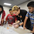 Jeanette Arnhart, a student at the University of Arkansas, shows students at J.O. Kelly Middle Schoo...