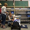 Laura Shephard-Johnson, field technician with the Washington County Election Commission, from right,...