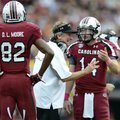 South Carolina coach Steve Spurrier talks to quarterback Connor Shaw asD. L. Moore looks on during t...