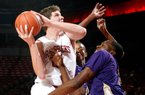 Arkansas sophomore Hunter Mickelson shoots over LeMoyne-Owen’s Edwin Shorter during the first half of Monday’s exhibition game. Mickelson had nine points and the Razorbacks won 111-45.