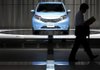 A visitor passes a Nissan Motor Co. Note on display Tuesday at company headquarters in Yokohama City, Japan. Nissan reported a profit of $1.3 billion in the July-to-September quarter. 