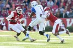  University of Arkansas linebacker A.J. Turner (left) and Tevin Mitchell put the stop on Tulsa receiver Keyarris Garrett during Saturdays homecoming game at Razorback Stadium.
