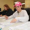 Jamie Fields, left, and Serena Green count paper ballots Wednesday at the Benton County Election Com...