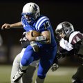 Nick Wary, Rogers High quarterback, carries the ball on a keeper play Oct. 26 during the game agains...