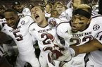 Texas A&M quarterback Johnny Manziel (2) is joined by wide receiver Kenric McNeal (5) and defensive back Dustin Harris (22) as they celebrate a win over top ranked Alabama during an NCAA college football game at Bryant-Denny Stadium in Tuscaloosa, Ala., Saturday, Nov. 10, 2012. Texas A&M won 29-24. (AP Photo/Dave Martin)