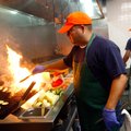 Oscar Garcia grills fish in the kitchen Friday during lunch at the Flying Fish restaurant in downtow...