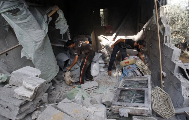 palestinians-look-through-their-belongings-in-a-house-destroyed-overnight-by-an-israeli-airstrike-in-beit-lahiya-northern-gaza-strip-sunday-nov-11-2012-hostilities-along-the-gaza-israel-border-escalated-sharply-over-the-weekend-with-rocket-salvos-from-gaza-and-israeli-strikes-killing-at-least-six-palestinians