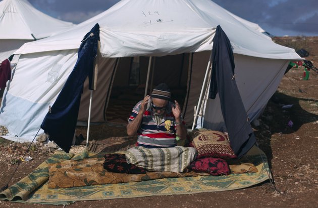 a-syrian-elderly-disabled-man-who-fled-from-the-violence-in-his-village-prays-in-front-of-his-tent-at-a-displaced-camp-in-the-syrian-village-of-atma-near-the-turkish-border-with-syria-saturday-nov-10-2012