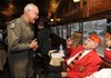 Retired Lt. Col. Steve Gray, military liaison to Sen. John Boozman, R-Rogers, left, speaks Sunday, Nov. 11, 2012, with James L. Quin, 87, of Springdale, a veteran of the U.S. Navy who served in World War II, Korea and Vietnam, during a Veterans Day observance aboard an Arkansas & Missouri Railroad passenger car at the railroad depot in Springdale.