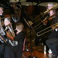 Members of the Ozark Mountains British Brass Band perform on stage in the auditorium on Sunday insid...