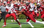 Arkansas Democrat-Gazette/STEPHEN B. THORNTON -- Arkansas' Cobi Hamilton, (11) runs by South Carolina' DeVonte Holloman , right, during the first quarter of their game Saturday afternoon in South Carolina. 