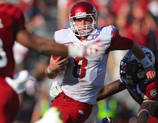 Arkansas Democrat-Gazette/STEPHEN B. THORNTON -- Arkansas QB Tyler Wilson eludes South Carolina defenders in the the third quarter during their game Saturday afternoon in South Carolina. 