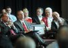 University of Arkansas chancellor G. David Gearhart, from left, athletics director Jeff Long, and former head football coach John L. Smith listen during a Sept. 14, 2012 ceremony for the university's new football center in Fayetteville.