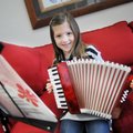 AnnieBeth Mabry, a third-grader at Turnbow Elementary School, holds on Thursday the accordion she is...