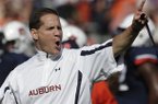 Auburn coach Gene Chizik talks with his team prior to the start of an NCAA college football game between Auburn and New Mexico State at Jordan-Hare Stadium in Auburn, Ala., Saturday, Nov. 3, 2012. (AP Photo/Dave Martin)