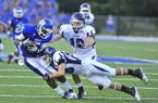 Bryant receiver K.J. Hill (left) is tackled by Conway safety (28) after catching a pass during a Aug. 31, 2012 game at Hornet stadium in Bryant.