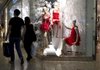 Shoppers pass a BCBG Max Azria store Monday at the Fair Oaks Mall in Fairfax, Va. Retail sales fell 0.3 percent in October after three months of gains. 