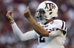 Texas A&M quarterback Johnny Manziel (2) reacts after the Aggies scored their third touchdown of the first quarter against Alabama during the first half of an NCAA college football game at Bryant-Denny Stadium in Tuscaloosa, Ala., Saturday, Nov. 10, 2012. (AP Photo/Dave Martin)