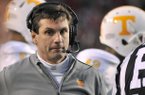 Tennessee coach Derek Dooley walks the sidelines during the first half of an NCAA college football game with Arkansas in Fayetteville, Ark., Saturday, Nov. 12, 2011. (AP Photo/April L. Brown)