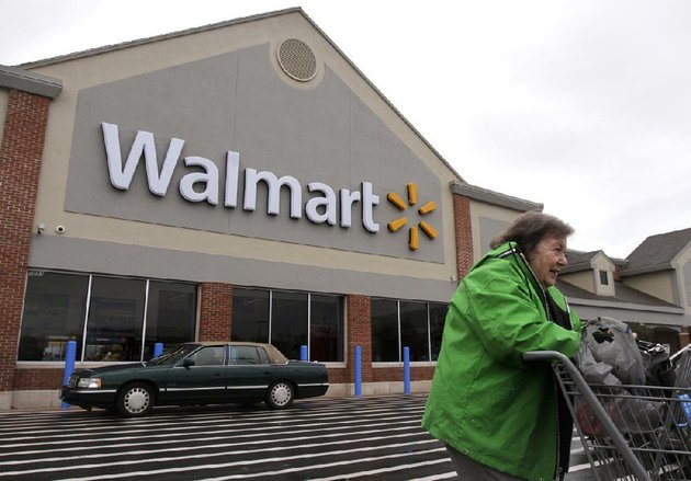 a-woman-exits-a-wal-mart-store-in-north-kingstown-ri-on-tuesday-wal-mart-stores-inc-on-thursday-reported-a-profit-of-364-billion