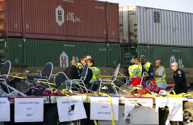 police-fire-and-sheriffs-personnel-respond-to-an-accident-in-which-a-flatbed-trailer-carrying-wounded-veterans-in-a-parade-was-struck-by-a-train-at-a-crossing-thursday-in-midland-texas