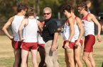 Arkansas Coach Chris Bucknam (center) and the Razorbacks are ranked 11th nationally heading into Saturday’s race. 