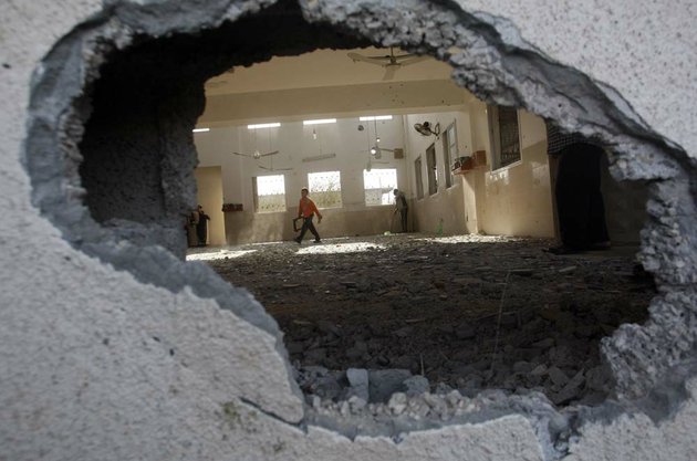 a-palestinian-child-walks-through-a-damaged-mosque-after-an-israeli-airstrike-in-beit-hanoun-northern-gaza-friday-nov-16-2012