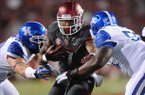 Running back Knile Davis (center), who has missed two games with a hamstring injury, has been cleared to play Saturday, Coach John L. Smith said. 