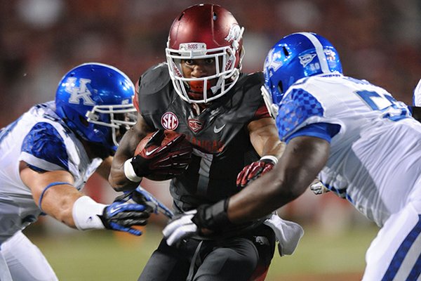 Running back Knile Davis (center), who has missed two games with a hamstring injury, has been cleared to play Saturday, Coach John L. Smith said. 