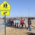 Heather Coon, right, Ruth Hale Barker Middle School physical education teacher, directs sixth-grader...