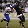 Tearris Wallace, right, a Bentonville running back, stiff-arms West Memphis defensive back Calman Cl...