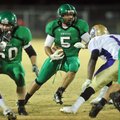 Calvin Jones of Greenland looks for a hole in the Osceola defense during the first half of Friday ni...