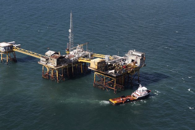 in-this-aerial-photograph-a-supply-vessel-moves-near-an-oil-rig-damaged-by-an-explosion-and-fire-friday-nov-16-2012-in-the-gulf-of-mexico-about-25-miles-southeast-of-grand-isle-la-four-people-were-transported-to-a-hospital-with-critical-burns-and-two-were-missing