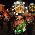 Santiago Rodriguez, (above) 17, walks with his sousaphone lit with lights down the parade route Frid...