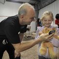 Rowdy Gaines, a 1984 Olympic gold medal swimmer, visits Friday with Leanne Jacobson, 9, of Rogers af...