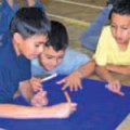 Giovanni Train, from left, Nicholas Sanchez and Jose Leon, all Monitor Elementary School students, w...