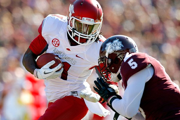 NWA Media/JASON IVESTER -- Arkansas senior wide receiver Cobi Hamilton is hit by Mississippi State junior Nicoe Whitley after making a touchdown catch during the first quarter on Saturday, Nov. 17, 2012, at Davis Wade Stadium in Starkville, Miss.