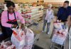 Lue Kelley (left) helps Sonic restaurant manager Thomas Ross (right) buy the last loaves of bread Friday at the Hostess Wonder Bread bakery outlet on Geyer Springs Road as Hostess Brands Inc. plans to close its factories. 