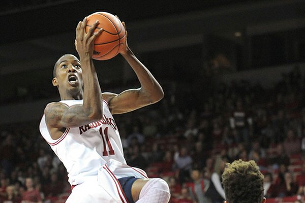 NWA Media/ANDY SHUPE -- Arkansas sophomore guard BJ Young (11) floats to the goal on Sunday, Nov. 18, 2012, during the first half of play in Bud Walton Arena.