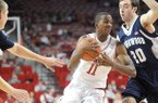 NWA Media/ANDY SHUPE -- Arkansas sophomore guard BJ Young, center, drives to the lane past Longwood freshman forward Karl Ziegler (20) Sunday, Nov. 18, 2012, during the first half of play in Bud Walton Arena.