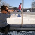 Silas Aldama, 3, wishfully watches ice skaters Saturday at Lawrence Plaza in Bentonville. Saturday w...