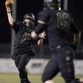 Reese Dollins, left, Bentonville’s quarterback, passes the ball to tight end Chase Morse on Friday d...