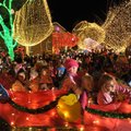 Parade floats make their way around the Fayetteville square Saturday during the annual lighting cere...