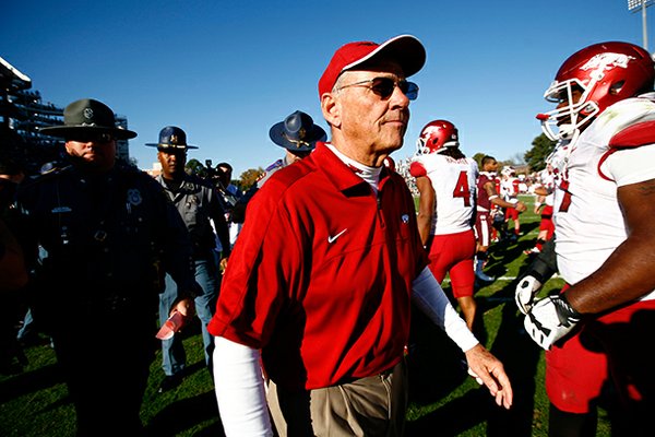 NWA Media/JASON IVESTER -- Arkansas head coach John L. Smith leaves the field following the Razorbacks' 45-14 loss to Mississippi State on Saturday, Nov. 17, 2012, at Davis Wade Stadium in Starkville, Miss.