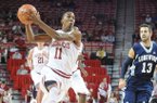 NWA Media/ANDY SHUPE -- Arkansas sophomore guard BJ Young (11) drives to the lane past Longwood junior guard David Robinson (13) Sunday, Nov. 18, 2012, during the first half of play in Bud Walton Arena.