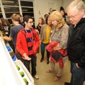 Daniel Carmona, a Fayetteville High School junior, left, explains a bucket garden system Nov. 8 to v...