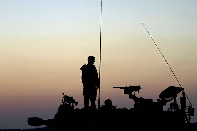 an-israeli-soldier-stands-on-top-of-a-mobile-artillery-unit-in-a-position-a-near-the-israel-gaza-border-southern-israel-on-tuesday-nov-20-2012
